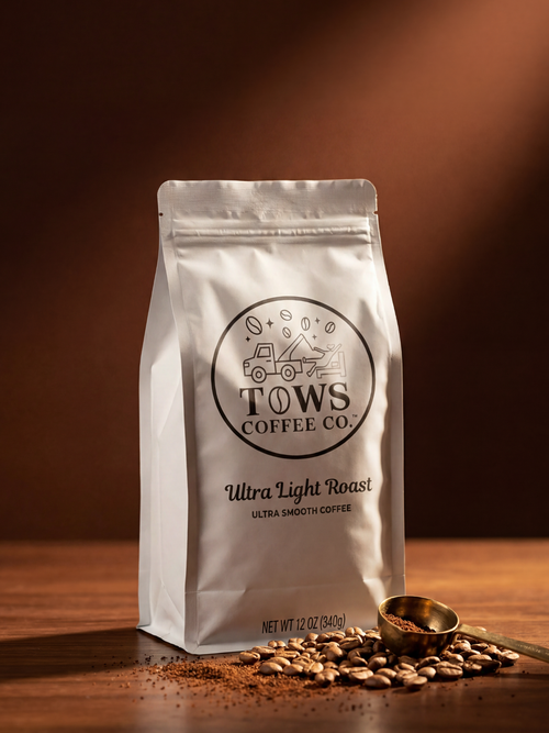 Coffee bag from Tows Coffee Co. on a wooden surface with coffee beans and a scoop.