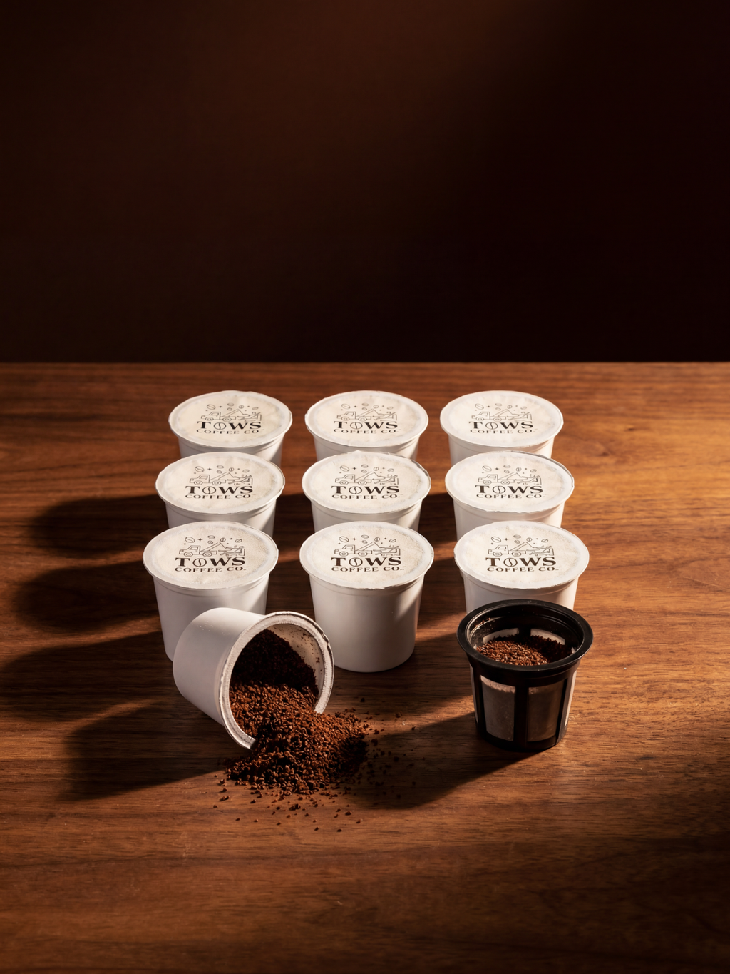 Tows Coffee Co Coffee pods on a wooden surface with a dark background