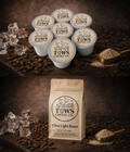 TOWS Coffee Co. coffee pods and a bag on a dark background with coffee beans and a spoon.