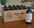 Tows White Coffee Cold Brew 12 Pack on a mahogany table
